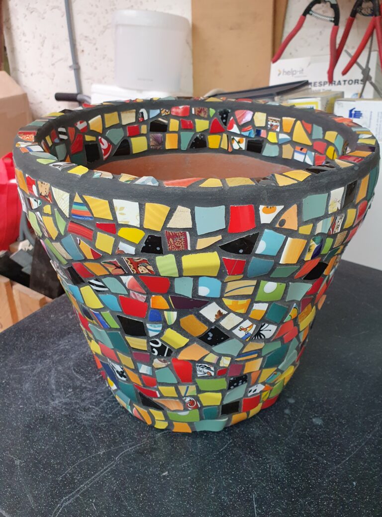 multicoloured mosaic pot with tessera around the inside of the top