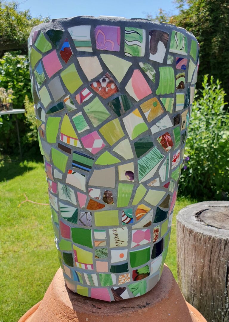 Tall mosaic pot in pink and green colouring.